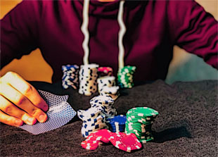 poker chips and hand on the table